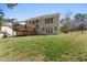 Landscaped backyard features a spacious lawn, deck, screened in porch and mature trees that provide shade and privacy at 12812 Baybriar Dr, Raleigh, NC 27613