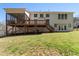 Expansive backyard features a well-manicured lawn and a large deck with screened in porch, great for outdoor living at 12812 Baybriar Dr, Raleigh, NC 27613