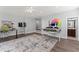 Basement with wood floors and large area rug used as craft and work space at 12812 Baybriar Dr, Raleigh, NC 27613