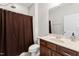 Cozy bathroom featuring a shower with a brown curtain, a toilet, and a vanity with a mirror at 12812 Baybriar Dr, Raleigh, NC 27613