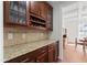 Built-in cabinetry and granite countertop in butler's pantry with wine storage at 12812 Baybriar Dr, Raleigh, NC 27613