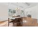 Dining room featuring hardwood floors, a coffered ceiling, and a transitional chandelier at 12812 Baybriar Dr, Raleigh, NC 27613
