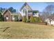 Charming two-story home featuring stone accents, a beautifully landscaped yard, and vibrant shrubbery at 12812 Baybriar Dr, Raleigh, NC 27613