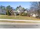 Two-story home with stone and siding exterior and a well-manicured lawn and shrubs at 12812 Baybriar Dr, Raleigh, NC 27613