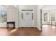 Bright foyer with hardwood floors and views into adjacent rooms with a white front door at 12812 Baybriar Dr, Raleigh, NC 27613