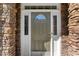 Close-up of an olive green front door with decorative sidelights and a stone surround at 12812 Baybriar Dr, Raleigh, NC 27613