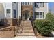 Front entryway showcases brick stairs with iron railings leading to an inviting front door with stone surround at 12812 Baybriar Dr, Raleigh, NC 27613