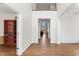 Hallway showcases hardwood floors and open sightlines into other rooms with white trim at 12812 Baybriar Dr, Raleigh, NC 27613