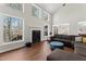 Sun-filled living room with fireplace and large windows to view outside scenery at 12812 Baybriar Dr, Raleigh, NC 27613