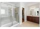 Elegant main bathroom with glass shower, vanity, tile floors, and walk-in closet at 12812 Baybriar Dr, Raleigh, NC 27613