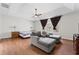 Spacious main bedroom featuring a tray ceiling, ceiling fan, and sitting area at 12812 Baybriar Dr, Raleigh, NC 27613
