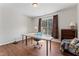 Office space featuring hardwood floors, a large desk with a blue chair, and a large window at 12812 Baybriar Dr, Raleigh, NC 27613