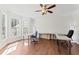 Home office featuring hardwood floors, a ceiling fan, and ample natural light with large windows at 12812 Baybriar Dr, Raleigh, NC 27613