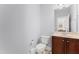Modern powder room with wooden vanity and tile floors at 12812 Baybriar Dr, Raleigh, NC 27613