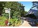 The Fearrington Barn with lush green landscaping and a rustic sign against a beautiful blue sky at 1309 Langdon Pl, Pittsboro, NC 27312