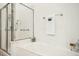 Bright bathroom showcasing a modern tub, a glass-enclosed shower, and sleek fixtures at 1309 Langdon Pl, Pittsboro, NC 27312