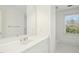 Well-lit bathroom featuring a pristine white vanity, large mirror, and a window offering plenty of light at 1309 Langdon Pl, Pittsboro, NC 27312