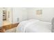Light-filled bedroom with wood floors, a comfortable bed, a doorway to a bathroom, and tasteful decor at 1309 Langdon Pl, Pittsboro, NC 27312