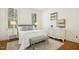 Serene bedroom featuring a cozy bed, a bench, and an elegant dresser with artwork, illuminated by natural light from windows at 1309 Langdon Pl, Pittsboro, NC 27312