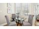 Cozy breakfast nook with a glass table, seating for four, and natural light at 1309 Langdon Pl, Pittsboro, NC 27312