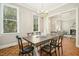Elegant dining room featuring a chandelier, a large window, and hardwood floors at 1309 Langdon Pl, Pittsboro, NC 27312