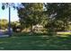 Exterior shot of a home nestled among trees with a lush green lawn at 1309 Langdon Pl, Pittsboro, NC 27312