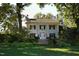 Stately home with a grand entrance framed by lush landscaping and mature trees at 1309 Langdon Pl, Pittsboro, NC 27312