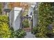 Charming home entrance featuring a decorative metal gate, lush greenery, and a stone pathway at 1309 Langdon Pl, Pittsboro, NC 27312