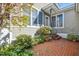 Inviting patio with brick flooring, garden plants, and a charming entrance with classic details at 1309 Langdon Pl, Pittsboro, NC 27312