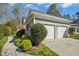 Attached two-car garage featuring well-maintained landscaping and a charming exterior at 1309 Langdon Pl, Pittsboro, NC 27312