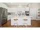 Modern kitchen with white cabinets, stainless steel appliances, and a breakfast bar at 1309 Langdon Pl, Pittsboro, NC 27312