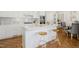 Modern kitchen with white cabinets, stainless steel appliances, and a breakfast bar at 1309 Langdon Pl, Pittsboro, NC 27312