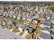 Aerial view of neighborhood with mature trees and houses with solar panels at 1445 Lombar St, Raleigh, NC 27610