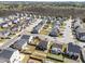 An aerial view showcases the neighborhood, surrounding woods, and meticulously planned home lots at 1445 Lombar St, Raleigh, NC 27610