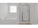 Bright bathroom with a soaking tub and separate glass-enclosed shower at 1445 Lombar St, Raleigh, NC 27610