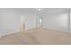 Carpeted bedroom with doorways to an adjacent bedroom and bathroom at 1445 Lombar St, Raleigh, NC 27610