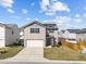 Charming two-story home featuring a two-car garage and neutral siding, complemented by a well-maintained lawn at 1445 Lombar St, Raleigh, NC 27610