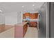Modern kitchen with a center island, stainless steel appliances, and wood cabinets for ample storage at 1445 Lombar St, Raleigh, NC 27610