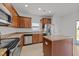 Contemporary kitchen featuring stainless steel appliances, granite countertops, and ample cabinet space at 1445 Lombar St, Raleigh, NC 27610