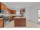 Well-equipped kitchen featuring stainless steel appliances, granite countertops, and wood cabinets at 1445 Lombar St, Raleigh, NC 27610