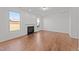 Spacious living room showcasing hardwood floors, recessed lighting, and a cozy fireplace with white trim at 1445 Lombar St, Raleigh, NC 27610