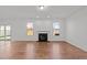 Well-lit living room with wood floors, a fireplace, and large windows providing ample natural light at 1445 Lombar St, Raleigh, NC 27610