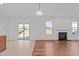 Cozy living room featuring a fireplace, wood floors, and a sliding glass door to the backyard at 1445 Lombar St, Raleigh, NC 27610