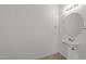 Simple powder room with a pedestal sink and neutral walls, offering a clean and functional space at 1445 Lombar St, Raleigh, NC 27610