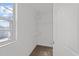 Bright walk-in closet with shelving, carpet, and window at 1445 Lombar St, Raleigh, NC 27610