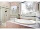 Bathroom featuring a soaking tub with jets and a seamless glass shower with custom tile work at 150 Green Haven Blvd # 67, Youngsville, NC 27596