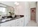 Bathroom with double vanity, granite counters, white cabinets, and a view to the backyard at 150 Green Haven Blvd # 67, Youngsville, NC 27596
