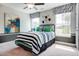 Bright bedroom with gray walls, striped bedding, and abstract art creates a stylish and comfortable space at 150 Green Haven Blvd # 67, Youngsville, NC 27596