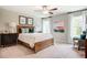 This cozy bedroom features a ceiling fan, a plush bed, and large windows for plenty of natural light at 150 Green Haven Blvd # 67, Youngsville, NC 27596