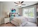 Comfortable bedroom with a ceiling fan, plush bedding, and a large window overlooking the property at 150 Green Haven Blvd # 67, Youngsville, NC 27596